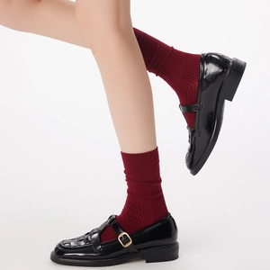 Retro Mary Jane shoes in black patent leather with deep red vertical striped wool socks