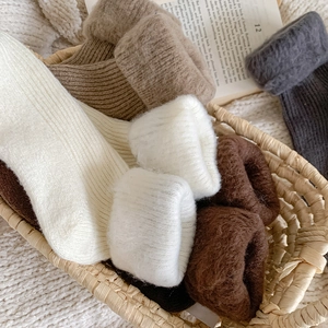 Detailed view of thick thermal winter socks with warm fleece lining in earthy tones