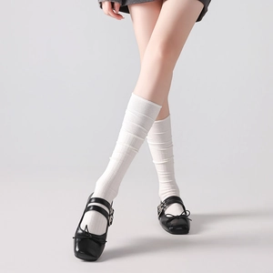 White wool calf socks with vertical stripes paired with black Mary Jane shoes