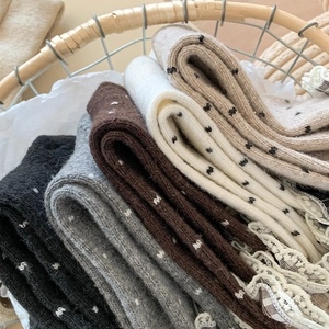 Detailed view of assorted retro wool socks with lace trim and dotted knit patterns