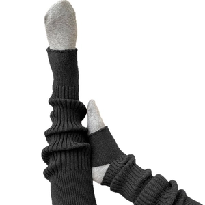 Fashionable black ribbed knit leg warmers with stirrup design for a layered autumn look
