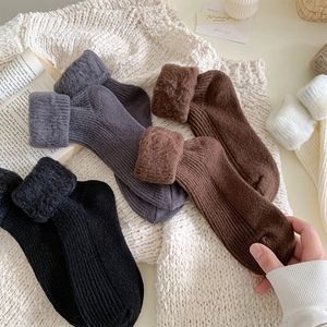 Detail of warm winter crew socks with thick fleece lining and cozy cable knit texture
