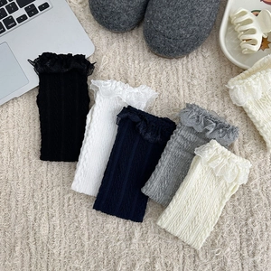 Five pairs of Japanese style cable knit socks with lace trim in neutral color tones