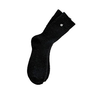 Thick black wool crew socks for women featuring ribbed texture and a silver button charm