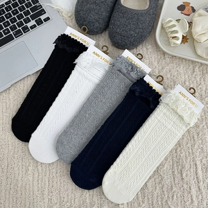 Detailed knit patterns and delicate lace trim on multi-color cotton mid-calf socks
