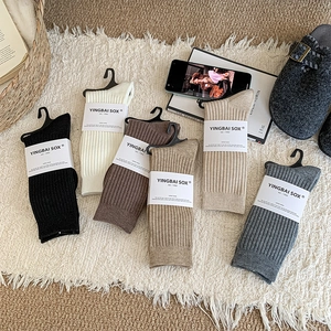 Detail of 6-pack ribbed cotton crew socks in earth tones with brand packaging cards