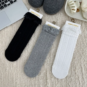 Set of three lace-trimmed crew socks in black, gray, and white with cable knit texture