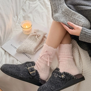 Cozy pink wool socks with ribbon bow detail paired with grey felt indoor slippers