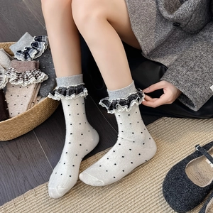 Vintage wool blend socks with lace trim and polka dots in cozy home setting