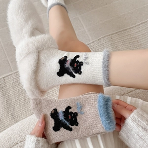 Close-up of winter wool socks featuring plush bear embroidery and cute fuzzy trim