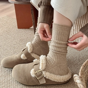 Detail of camel suede mule slippers with faux sheepskin lining and adjustable buckle strap