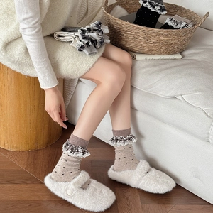 Polka dot wool socks with lace trim paired with cozy white plush home slippers