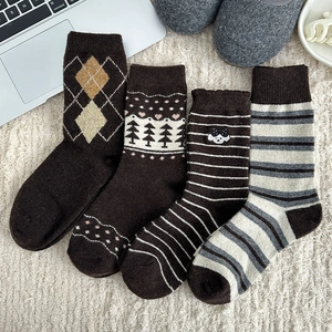 Detailed knit texture of vintage wool socks featuring brown stripes and dog embroidery motifs