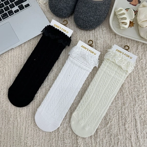 Detailed knit texture and lace trim on cotton crew socks in black and white colors