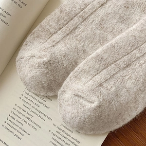 Close-up of thick oatmeal wool knit socks with premium soft texture and warm fabric