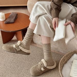 Chunky ribbed knit slouch socks for women styled with fleece-lined Birkenstock shoes