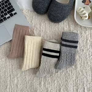Detailed knit texture of wool socks in grey and brown for winter indoor comfort