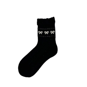 Japanese style black wool socks with gray bow patterns and ruffled bubble trim for women