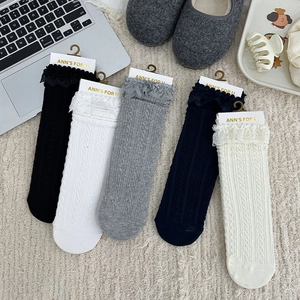 Detail of five pairs of cotton crew socks with delicate lace trim and cable knit texture