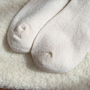 Close-up of seamless toe stitching and thick knit texture on warm wool socks