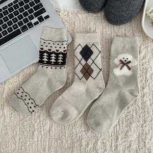 Detailed knit of Fair Isle wool socks with cute teddy dog and Nordic heart patterns