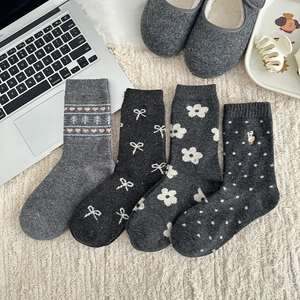 Close-up of Fair Isle style wool socks with embroidery and polka dots for winter