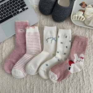 Five pack of sweet pink wool socks with floral patterns and cute rabbit designs