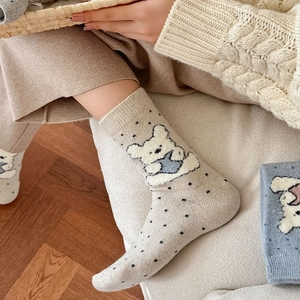 Close-up of knit bear socks with polka dots showing soft cotton texture and ribbed cuff