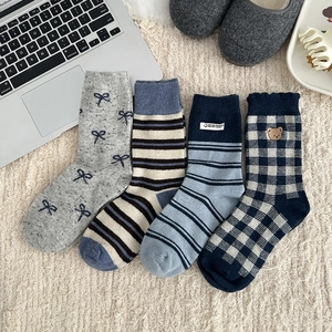 Detailed set of four Japanese style wool socks featuring stripes and bear embroidery