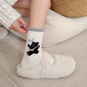 Thick wool socks with cute cartoon bear and plush cuff paired with cozy white slippers