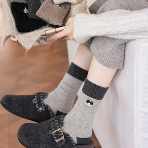 Detailed view of embroidery pattern and thick knitted texture of women wool socks