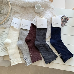 Detail of five-pair wool sock set featuring side letter embroidery and ribbed texture
