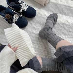 Detailed knit texture of warm coffee series cotton crew socks on cozy white carpet