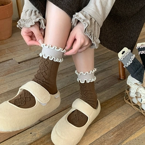 Detail of wool blend socks featuring embossed diamond pattern and ruffled trim edges