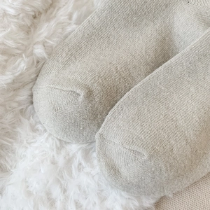 Close-up of the knitted toe area of warm wool socks with detailed stitching and texture