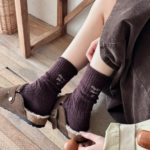 Deep purple wool crew socks with white letter embroidery worn with suede buckle slippers