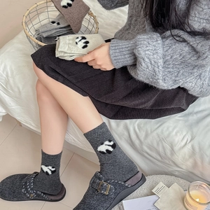 Detail of wool blend panda socks showing thick knit texture and cute panda pattern embroidery