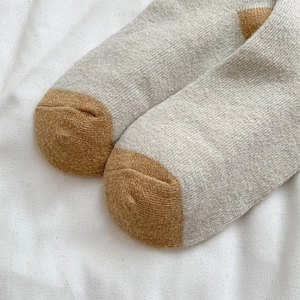 Close-up of knit texture and color-blocked toe on warm wool socks for winter