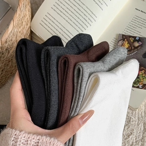 Detailed view of five solid-colored ribbed calf socks in a soft cotton blend