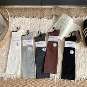 Detail view of five-pack knitted compression socks in assorted neutral winter colors