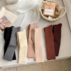 Detailed knit texture of ribbed calf socks in a variety of minimalist warm tones