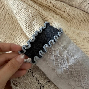 Close-up of vintage argyle pattern wool socks with ruffles and soft cable knit texture