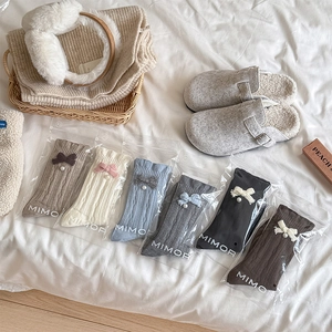 Detail of wool socks with bow tie and pearl charm in six assorted autumn colors