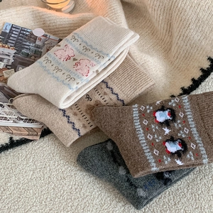 Detailed knit texture of thick winter socks with cute cartoon bear and rabbit patterns