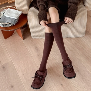 Detail of dark brown ribbed calf socks showing high elasticity and soft cotton texture