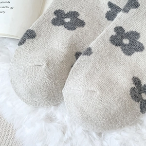 Detail shot of vintage wool socks showing knitted floral pattern and gray toe texture