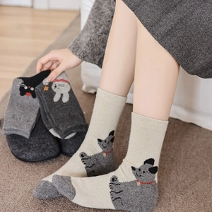 Detail of warm wool blend socks featuring cute cartoon bear patterns and ribbed cuffs