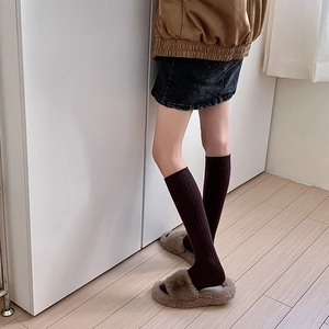 Detail view of dark coffee rib-knit calf socks with textured vertical stripe pattern