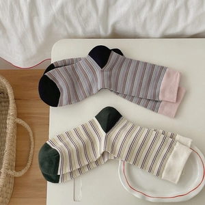 Detail of vintage striped cotton mid-calf socks with ribbed cuffs and contrast colors