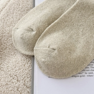 Macro detail of warm wool blend socks showing the dense knit texture and toe stitching